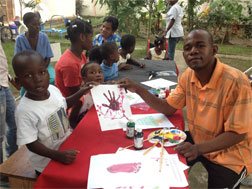 Amputee football player Francillon Chery teachs art to children.